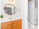 Bright bathroom with a wood vanity, decorative mirror, and access to the commode and shower area at 5321 Kathryn Blair Ln, Charlotte, NC 28226