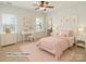 A staged bedroom features pastel colors, windows, and simple decor at 5321 Kathryn Blair Ln, Charlotte, NC 28226