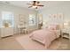 Bright bedroom featuring a bed with decorative pillows and matching dressers with lamps at 5321 Kathryn Blair Ln, Charlotte, NC 28226