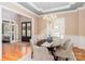 Elegant dining room features wainscoting, a chandelier, and plantation shutters for a sophisticated ambiance at 5321 Kathryn Blair Ln, Charlotte, NC 28226