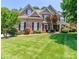 Charming two-story brick home with a well-manicured lawn and lush landscaping at 5321 Kathryn Blair Ln, Charlotte, NC 28226