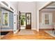 Welcoming foyer with hardwood floors, a transom window and an open view to the outdoors at 5321 Kathryn Blair Ln, Charlotte, NC 28226