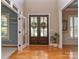 Elegant foyer with hardwood floors, double doors, and natural light at 5321 Kathryn Blair Ln, Charlotte, NC 28226