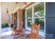 Inviting front porch with rocking chairs and charming brick accents showcasing curb appeal at 5321 Kathryn Blair Ln, Charlotte, NC 28226