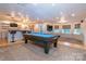 Enjoy a game of pool in this finished basement with hardwood floors and a custom bar at 5321 Kathryn Blair Ln, Charlotte, NC 28226