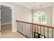 Bright hallway with stylish railing leading to additional rooms and a beautiful window at 5321 Kathryn Blair Ln, Charlotte, NC 28226