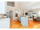 Open kitchen with a view into the living room, featuring white cabinetry and wood floors at 5321 Kathryn Blair Ln, Charlotte, NC 28226