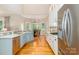 Bright kitchen with a gas cooktop, stainless steel appliances, white cabinets and hardwood floors at 5321 Kathryn Blair Ln, Charlotte, NC 28226