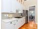 Modern kitchen with stainless steel appliances, white cabinets and hardwood floors at 5321 Kathryn Blair Ln, Charlotte, NC 28226