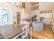 Bright kitchen with stainless steel appliances, center island, and adjacent dining area featuring a large window at 5321 Kathryn Blair Ln, Charlotte, NC 28226