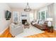 Bright living room featuring a fireplace, large windows and hardwood floors at 5321 Kathryn Blair Ln, Charlotte, NC 28226