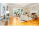 Bright living room with large windows, hardwood floors, fireplace, and neutral-toned furniture at 5321 Kathryn Blair Ln, Charlotte, NC 28226