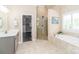 Luxurious main bathroom with a walk-in shower, soaking tub, and double vanity, offering a spa-like experience at 5321 Kathryn Blair Ln, Charlotte, NC 28226
