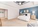 Primary bedroom boasts an accent wall, a tray ceiling with fan, and cozy carpeting at 5321 Kathryn Blair Ln, Charlotte, NC 28226