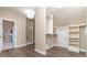Bright walk-in closet featuring custom shelves with an open door leading to the Primary bath at 5321 Kathryn Blair Ln, Charlotte, NC 28226