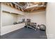 Home workout room equipped with weights, a bench, mirror and a rubber floor at 5321 Kathryn Blair Ln, Charlotte, NC 28226