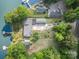Aerial view of a lakeside property featuring private dock and ample parking at 565 Shore Acres Rd, Salisbury, NC 28146