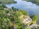 Expansive lake view with mature trees surrounds lakefront property with private dock at 565 Shore Acres Rd, Salisbury, NC 28146