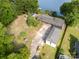 Stunning aerial view of lakefront home with private dock and lush green surroundings at 565 Shore Acres Rd, Salisbury, NC 28146