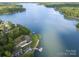 Beautiful lake view with property featuring lake access, surrounded by lush greenery at 565 Shore Acres Rd, Salisbury, NC 28146