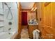 Cozy bathroom featuring wood walls, tiled shower and ample counter space at 565 Shore Acres Rd, Salisbury, NC 28146
