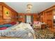 Bedroom featuring wood walls, two chandeliers and a patterned rug at 565 Shore Acres Rd, Salisbury, NC 28146