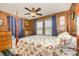 Bedroom with four poster bed, wood walls, and natural light from windows at 565 Shore Acres Rd, Salisbury, NC 28146