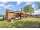 Brick home with outdoor seating, overlooking the large yard space with mature trees at 565 Shore Acres Rd, Salisbury, NC 28146