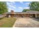 Welcoming brick home featuring a covered front porch and a spacious driveway with ample parking at 565 Shore Acres Rd, Salisbury, NC 28146