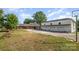 Spacious home featuring an attached garage and a large driveway, set on a well-manicured lawn at 565 Shore Acres Rd, Salisbury, NC 28146