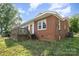 Brick house with a deck overlooking the yard, showcasing its potential for outdoor activities at 565 Shore Acres Rd, Salisbury, NC 28146