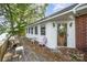 Charming exterior showcasing a mix of brick and white siding, complemented by a wooden deck at 565 Shore Acres Rd, Salisbury, NC 28146