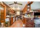 Unique kitchen featuring brick walls, wooden cabinets, and classic appliances, full of vintage charm at 565 Shore Acres Rd, Salisbury, NC 28146