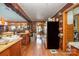 Spacious kitchen with brick accents, wood cabinets, and open layout connected to dining area at 565 Shore Acres Rd, Salisbury, NC 28146