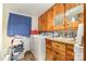 Bright laundry area features natural wood cabinets, sink, and washer and dryer hookups at 565 Shore Acres Rd, Salisbury, NC 28146