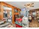 Living room includes wood paneled walls, ceiling fan, and lots of personal items at 565 Shore Acres Rd, Salisbury, NC 28146