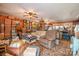Spacious living room with wood paneling, multiple ceiling fans, and lots of clutter at 565 Shore Acres Rd, Salisbury, NC 28146