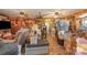 Large living room with wood paneled walls, ceiling fans and lots of personal items at 565 Shore Acres Rd, Salisbury, NC 28146