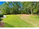Expansive backyard featuring lush green grass and mature trees, perfect for outdoor activities at 5903 Wm Griffin Rd, Monroe, NC 28112