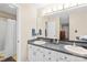 Spacious bathroom featuring a dual sink vanity, large mirror, and modern fixtures at 5903 Wm Griffin Rd, Monroe, NC 28112
