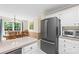 Modern kitchen featuring stainless steel refrigerator, microwave, and adjacent dining area with natural light at 5903 Wm Griffin Rd, Monroe, NC 28112