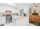 Charming kitchen featuring white cabinetry, stainless steel appliances, and open layout to living area at 5903 Wm Griffin Rd, Monroe, NC 28112