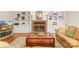 Cozy living room featuring a brick fireplace, built-in cabinets, and hardwood floors at 5903 Wm Griffin Rd, Monroe, NC 28112