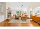 Spacious living room featuring hardwood floors, brick fireplace, and ample natural light at 5903 Wm Griffin Rd, Monroe, NC 28112