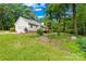 View of the home's side yard leading to a spacious deck overlooking the lush backyard and garage access at 5903 Wm Griffin Rd, Monroe, NC 28112