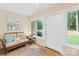 Bright sunroom featuring a comfortable wicker couch, tiled floors, and lots of natural light at 5903 Wm Griffin Rd, Monroe, NC 28112