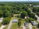 An aerial view showcasing the property and neighborhood with lush greenery, city skyline in distance, and a clear blue sky at 6034 Tuckaseegee Rd, Charlotte, NC 28208
