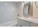 Bright bathroom featuring white tile, modern fixtures, and a stylish vanity with tub at 6034 Tuckaseegee Rd, Charlotte, NC 28208