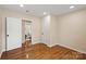 Bedroom featuring hardwood floors and a door leading to another room at 6034 Tuckaseegee Rd, Charlotte, NC 28208