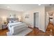 Bright bedroom with hardwood floors, a queen-size bed and neutral paint at 6034 Tuckaseegee Rd, Charlotte, NC 28208